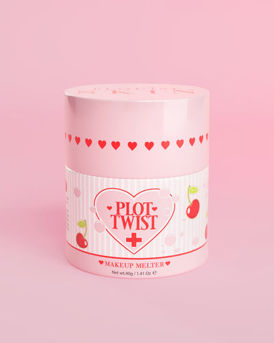 A pink container of P.Louise Plot Twist Makeup Melting Cleansing Balm with heart and cherry designs on the label against a pink background