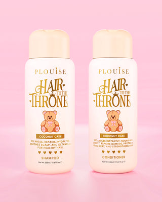 Two bottles of P.Louise Hair to the Throne Coconut Cake shampoo and conditioner on a pink background
