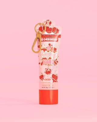 Tube of P. Louise A Helping Hand Hand Cream with a cherry design on a pink background