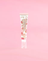 Tube of P. Louise Dose Of Dreams Vitamin C Brightening Eye Cream on a pink background