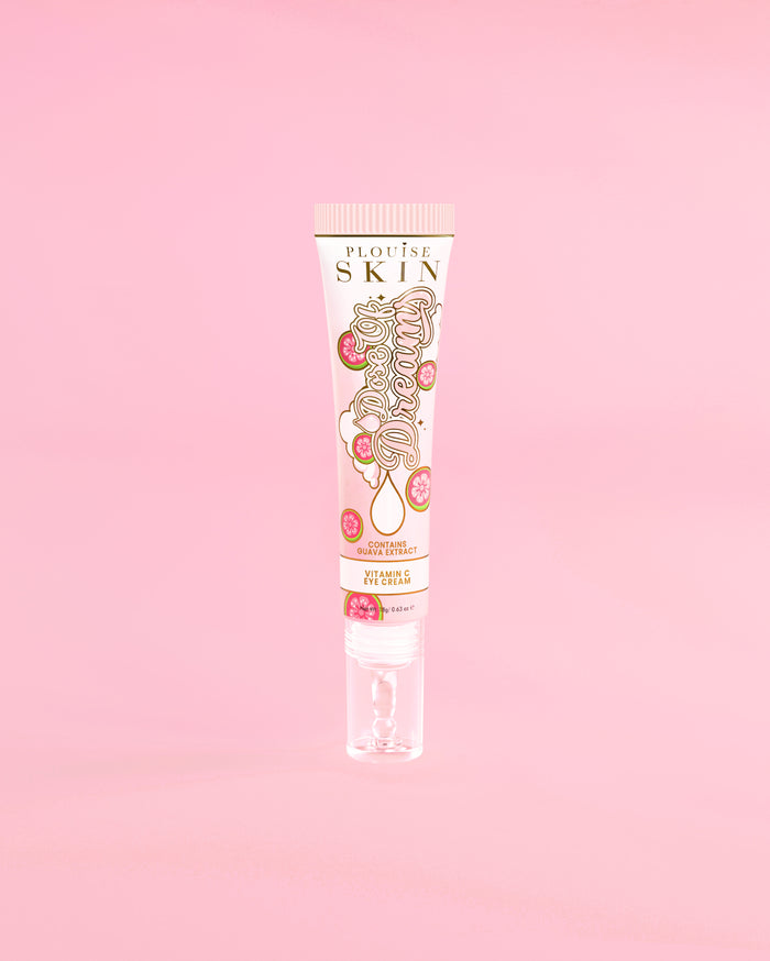 Tube of P. Louise Dose Of Dreams Vitamin C Brightening Eye Cream on a pink background