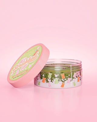 Open jar of P. Louise All Scrubbed Up Body Scrub in Gummy Bears scent on a pink background