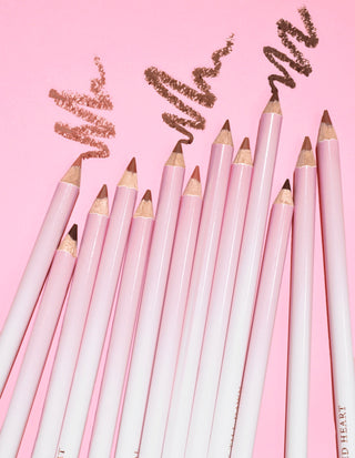 An image of multiple P.Louise Ultimate Definition Sharpenable Lip Liners grouped together showing some product drawn above them on a pink background