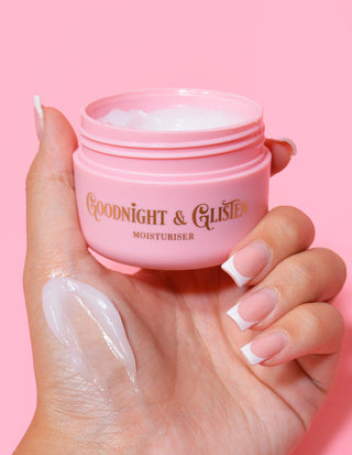 A hand holding a pink jar of P.Louise Goodnight & Glisten Gel Moisturiser with some moisturiser visible on the .and